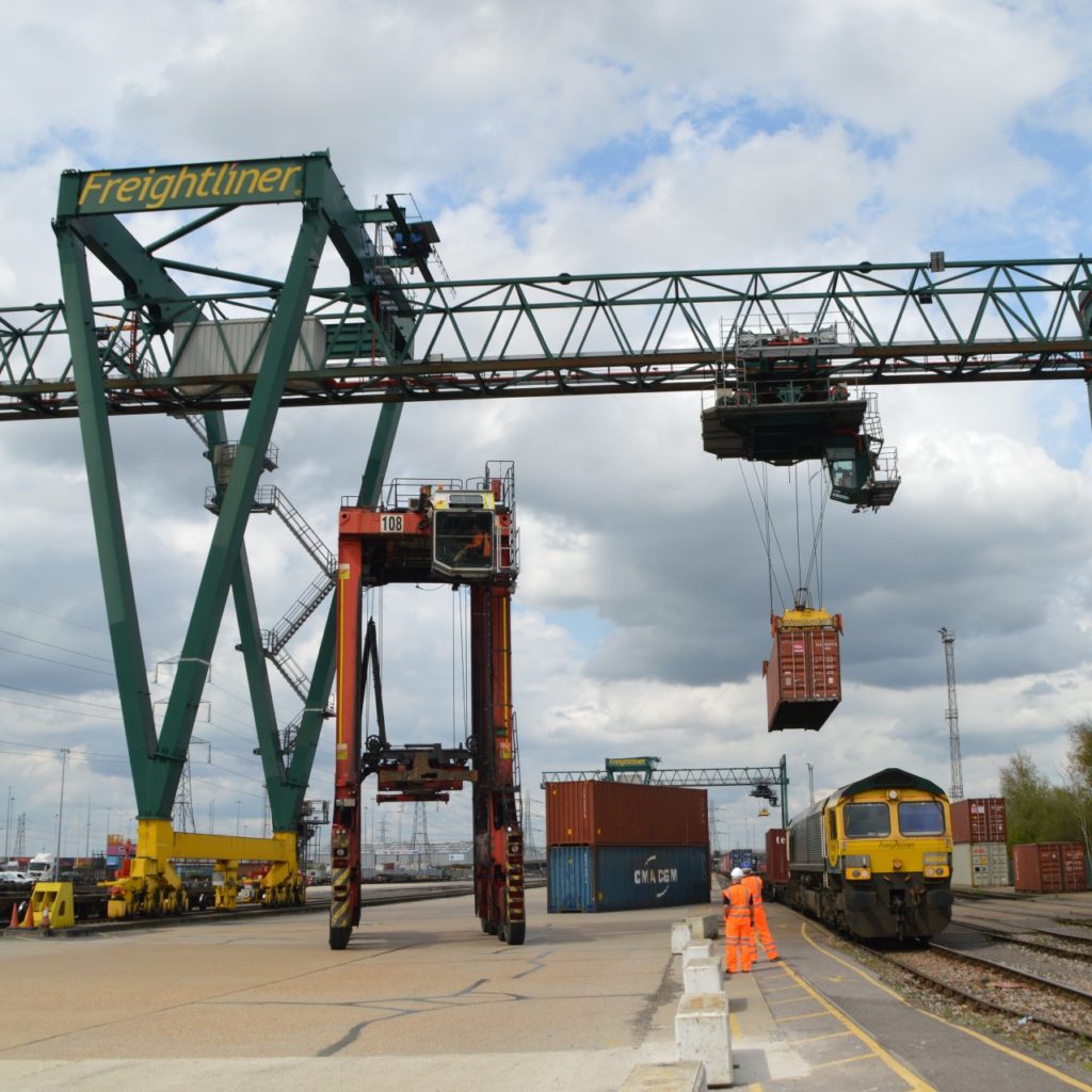 with train and crane and people inspecting them