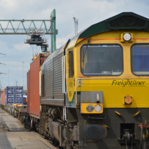 Freightliner depot with train in foreground square