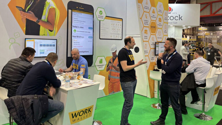 People networking and demonstrating the Work Wallet platform at an exhibition booth