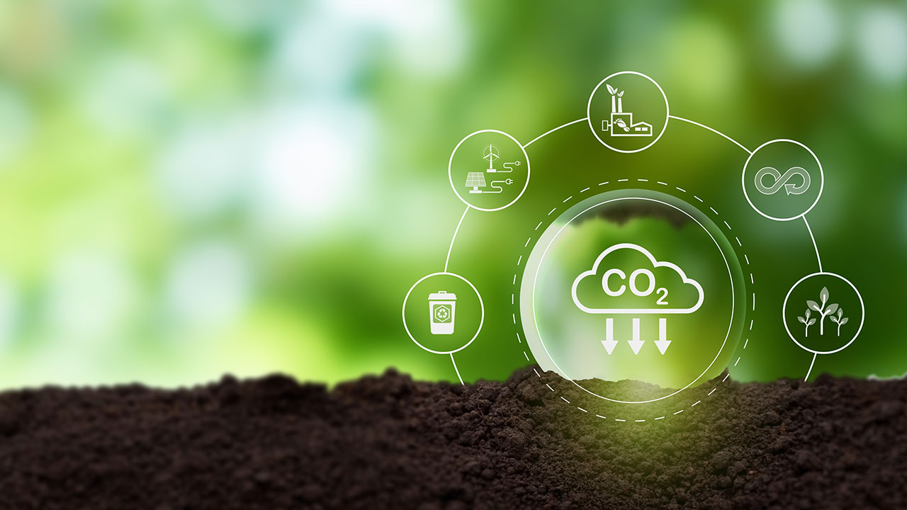 Soil with eco icons representing carbon reduction, recycling, and sustainable energy