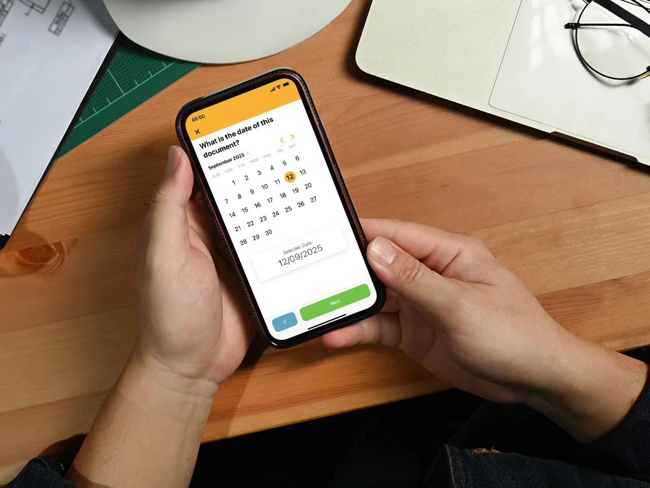 Person using Work Wallet app calendar to select a document date on smartphone