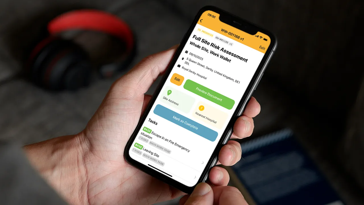 Person holding smartphone showing a full site risk assessment screen in Work Wallet