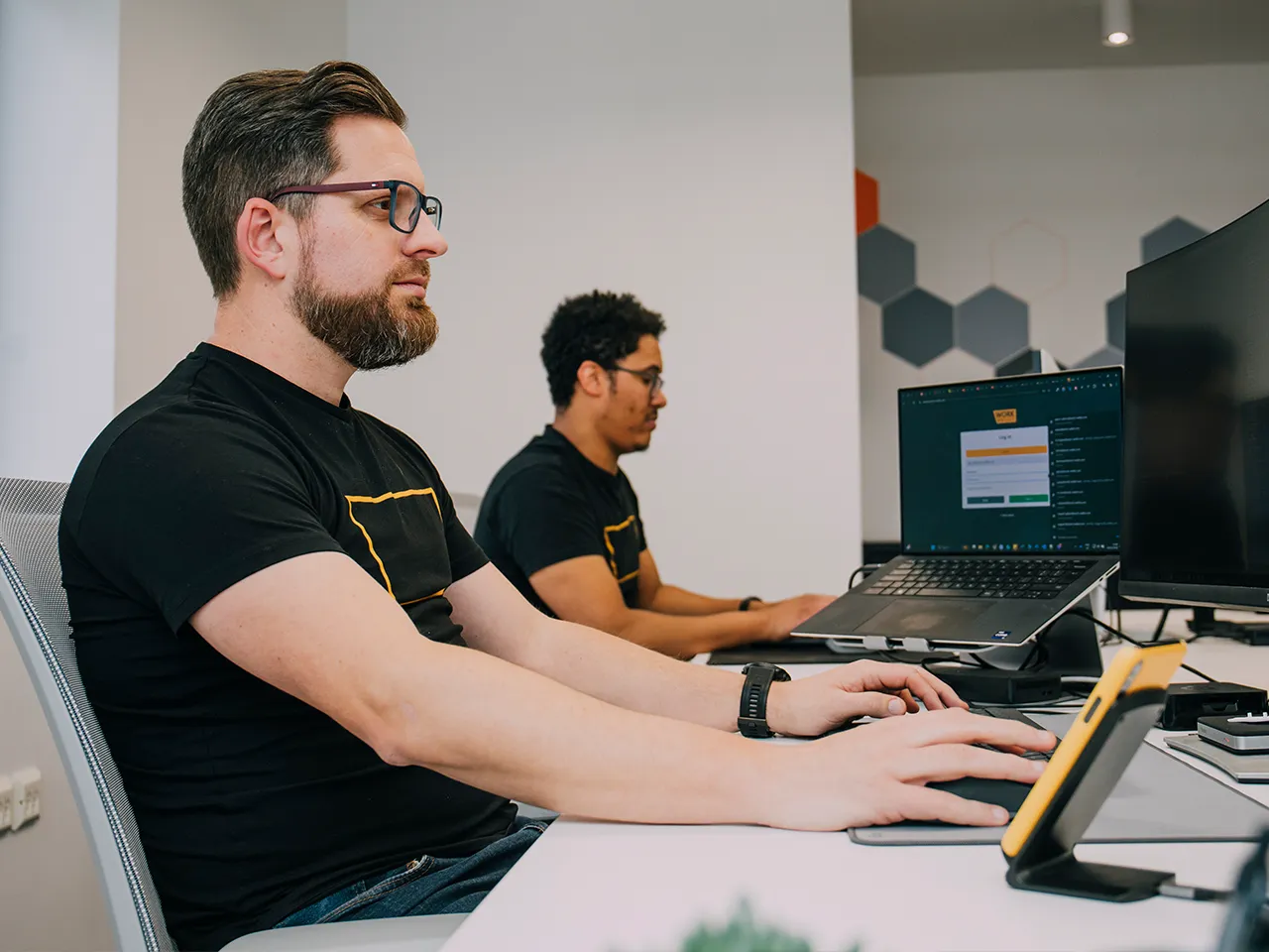 Work Wallet developers focused on coding at their desks in the office