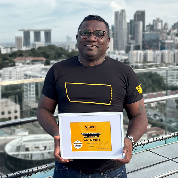 Person holding a framed Work Wallet Safety Champion of the Month certificate outdoors