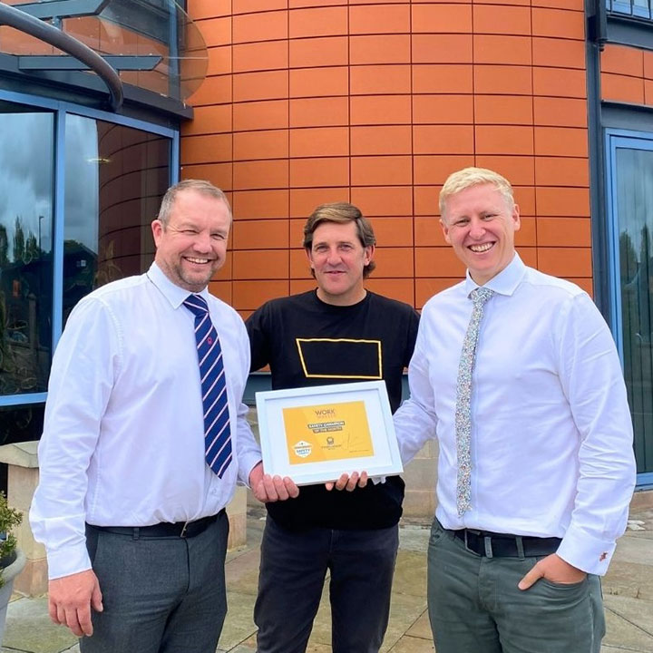 A Work Wallet team member presents a Work Wallet Safety Champion award