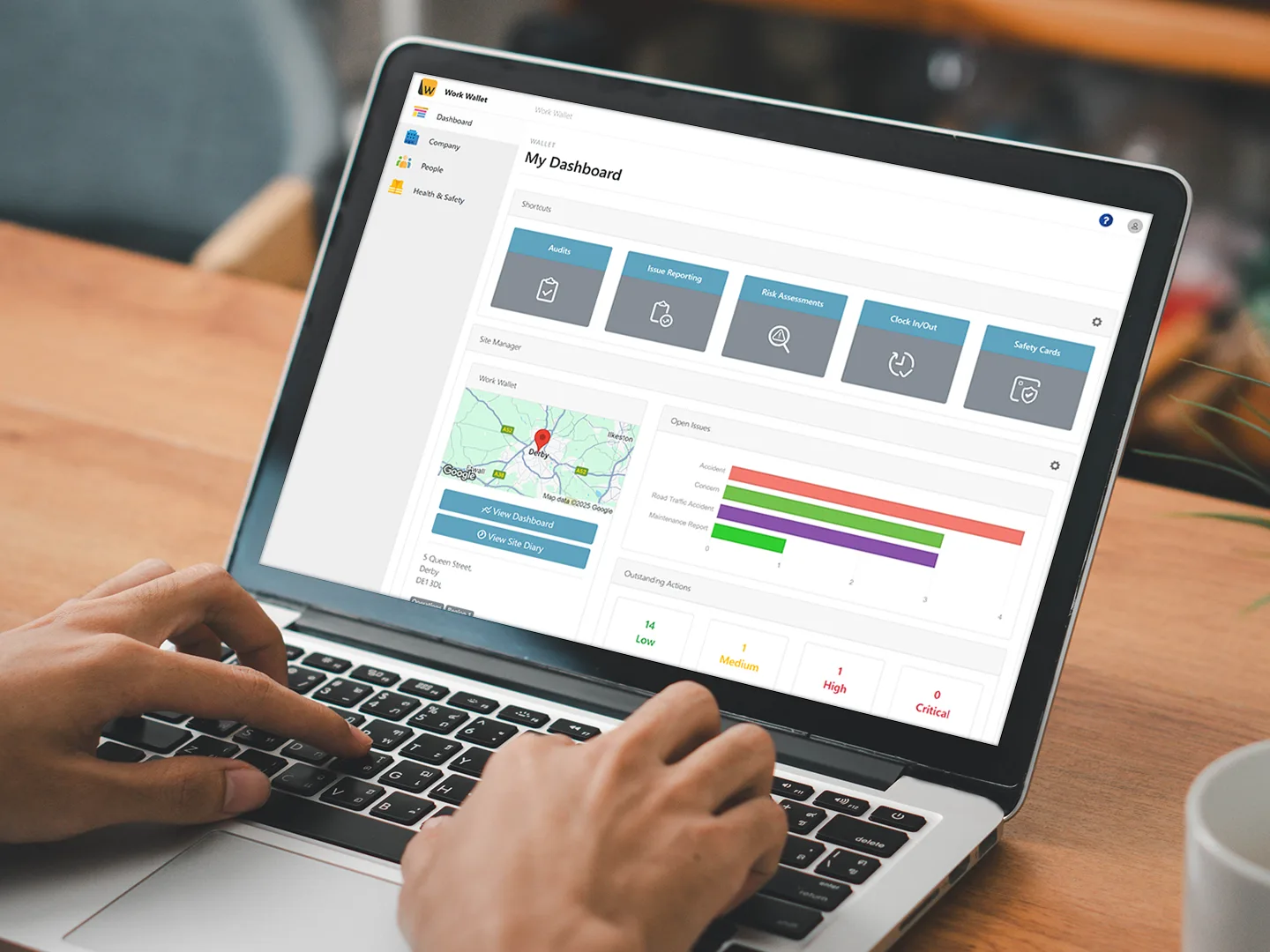 Hands typing on a laptop displaying a Work Wallet dashboard